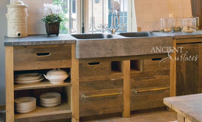 Hand Carved Double Basalt Sink with Reclaimed Wood Cabinets and Antique Stone Floors.
