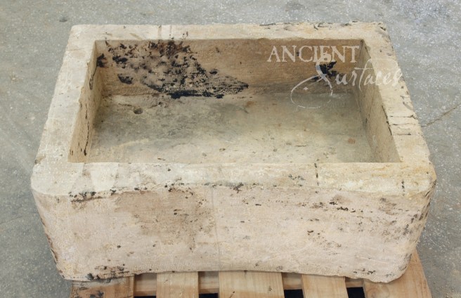 A perfect ergonometrically carved limestone sink reclaimed from a French farmhouse.