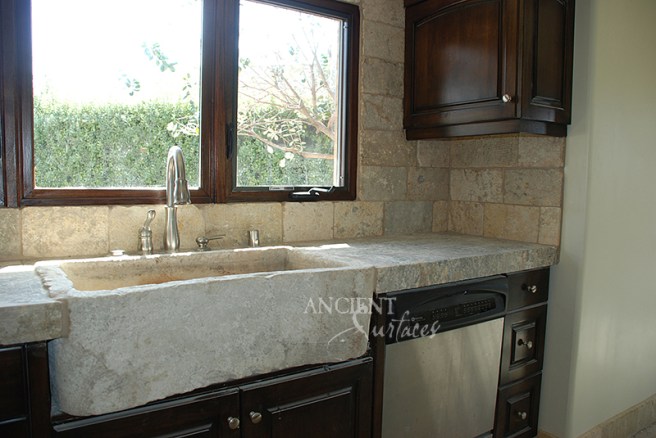 Antique Biblical Stone on the backsplash, antique foundation Slabs on the counter tops and a reclaimed 400 years old Italian Farmhouse sink.